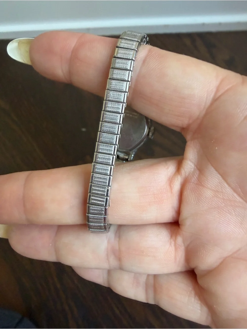 Vintage Timex Watch with an oval silver-tone dial and a flexible expansion band